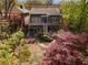 Aerial view of the rear exterior of the home, highlighting decks, stone patio and lush landscape at 462 N Highland Ave, Atlanta, GA 30307