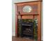 Close up of beautiful fireplace, showcasing green tiles and carved wood at 462 N Highland Ave, Atlanta, GA 30307