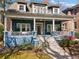 Charming two-story home with a welcoming front porch, beautiful landscaping, and classic architectural details at 462 N Highland Ave, Atlanta, GA 30307