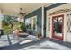 Inviting front porch with seating, plants, and a stylish red front door, creating a perfect spot for relaxation at 462 N Highland Ave, Atlanta, GA 30307