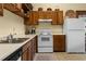 Bright kitchen with vintage wooden cabinets and white appliances at 462 N Highland Ave, Atlanta, GA 30307