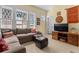 A comfortable living room with windows with diamond lattice, sofa, ottomans, and TV at 462 N Highland Ave, Atlanta, GA 30307