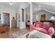 Open living room with bedroom and bathroom views, area rug, pink sofa, and wood floors at 462 N Highland Ave, Atlanta, GA 30307