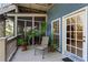 A shaded porch with a chair and view of the backyard and screened-in porch at 462 N Highland Ave, Atlanta, GA 30307