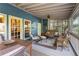 A cozy screened-in porch with comfortable seating and an outdoor dining area at 462 N Highland Ave, Atlanta, GA 30307