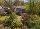 Aerial view of the rear exterior of the home, showcasing the decks, patios and landscaping at 462 N Highland Ave, Atlanta, GA 30307