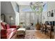 Bright sun room with French doors, large windows, potted plants, sofa, and desk at 462 N Highland Ave, Atlanta, GA 30307