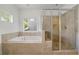Bathroom featuring a separate shower and soaking tub by the window at 52 Lath House Ln, Marietta, GA 30066
