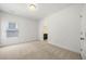 Bright bedroom features neutral carpeting and a glimpse into the attached bathroom at 52 Lath House Ln, Marietta, GA 30066