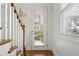 Bright entryway featuring a wooden staircase, hardwood floors, and a glass-paned door at 52 Lath House Ln, Marietta, GA 30066