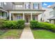 Inviting front porch with classic columns and lush landscaping, enhancing curb appeal at 52 Lath House Ln, Marietta, GA 30066