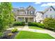 Charming home featuring a welcoming front porch, manicured lawn, and lush landscaping at 52 Lath House Ln, Marietta, GA 30066