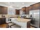 Modern kitchen with stainless steel appliances, granite counters, island with breakfast bar, and dark wood cabinetry at 52 Lath House Ln, Marietta, GA 30066