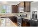 Updated kitchen boasts granite countertops, stainless appliances, and gas range cooktop at 52 Lath House Ln, Marietta, GA 30066