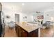 Open concept kitchen with island, stainless steel appliances, eat-in dining area, and hardwood floors at 52 Lath House Ln, Marietta, GA 30066