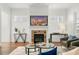 Cozy living room featuring a stone fireplace, hardwood floors, and stylish furnishings at 52 Lath House Ln, Marietta, GA 30066