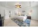 Spacious main bedroom with tray ceiling, ceiling fan, and a stylish blue area rug at 52 Lath House Ln, Marietta, GA 30066