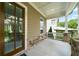 Inviting porch with stone accents and a large wooden door with glass inserts at 52 Lath House Ln, Marietta, GA 30066