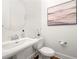 Clean powder room has a pedestal sink, modern fixtures, and decor at 52 Lath House Ln, Marietta, GA 30066