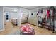 Spacious bedroom with wood flooring, a comfortable bed, and a view to another room at 5573 Singleton Rd, Norcross, GA 30093