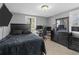 Stylish bedroom featuring modern furnishings, tile floors, and natural light at 5573 Singleton Rd, Norcross, GA 30093