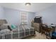 Light-filled bedroom with a large window, desk, and dresser at 5573 Singleton Rd, Norcross, GA 30093