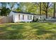 Well-maintained single-story home with spacious front yard, mature trees, and ample parking at 5573 Singleton Rd, Norcross, GA 30093