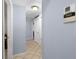 Hallway with tile flooring, neutral walls, and access to various rooms in the home at 5573 Singleton Rd, Norcross, GA 30093
