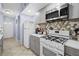 Updated kitchen features stainless steel appliances, modern cabinetry, and a stylish backsplash at 5573 Singleton Rd, Norcross, GA 30093