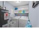 Efficient laundry room with washer, dryer, and storage shelves at 5573 Singleton Rd, Norcross, GA 30093