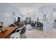 Spacious living room with ample seating, ceiling fan, and view into kitchen and bar area at 5573 Singleton Rd, Norcross, GA 30093