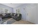 Comfortable living room featuring a large sectional sofa, bright windows, and neutral decor at 5573 Singleton Rd, Norcross, GA 30093