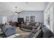 Bright and airy living room with tile floors, ceiling fan, large sectional, and natural light at 5573 Singleton Rd, Norcross, GA 30093