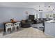 Open concept living space with large sectional, vaulted ceiling, and tiled floors at 5573 Singleton Rd, Norcross, GA 30093