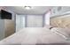 Inviting bedroom with a plush bed, neutral tones, and ample natural light streaming through the window at 5573 Singleton Rd, Norcross, GA 30093
