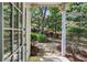 Charming backyard view from the back door, featuring a lush garden and mature trees for privacy at 908 Hollyfax Cir, Sandy Springs, GA 30328