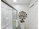 Bathroom with a shower and tub combination and a modern decorative wall hanging at 908 Hollyfax Cir, Sandy Springs, GA 30328