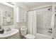 Bright bathroom includes shower/tub combination and white fixtures at 908 Hollyfax Cir, Sandy Springs, GA 30328