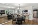 Elegant dining area open to the kitchen with a mirrored wall and stylish lighting fixture at 908 Hollyfax Cir, Sandy Springs, GA 30328