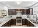 Well-equipped kitchen with stainless steel appliances, granite countertops, and ample cabinet space at 908 Hollyfax Cir, Sandy Springs, GA 30328