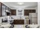 Kitchen with ample granite countertops, stainless steel appliances, and brown cabinets at 908 Hollyfax Cir, Sandy Springs, GA 30328