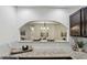 Kitchen passthrough with white subway tile and granite countertops, offering a view of the living area at 908 Hollyfax Cir, Sandy Springs, GA 30328
