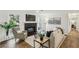 Comfortable living room featuring a fireplace, large windows, and stylish decor for a cozy atmosphere at 908 Hollyfax Cir, Sandy Springs, GA 30328