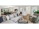 Bright open-concept living room with contemporary furnishings, flowing seamlessly into the dining and kitchen areas at 908 Hollyfax Cir, Sandy Springs, GA 30328