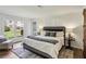 Bright main bedroom features a large window with great views and a rustic barn door to the ensuite bathroom at 908 Hollyfax Cir, Sandy Springs, GA 30328