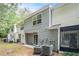 Back exterior with vinyl siding, a small patio, and an air conditioning unit at 1728 Devon Sw Dr, Atlanta, GA 30311