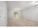 Clean, carpeted basement area with a sliding glass door offering outdoor access and plenty of light at 1728 Devon Sw Dr, Atlanta, GA 30311