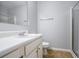 Clean bathroom featuring a vanity with sleek fixtures, a toilet, and a glass-enclosed shower, offering a refreshing experience at 1728 Devon Sw Dr, Atlanta, GA 30311