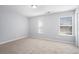 This bedroom is bright with two large windows and neutral carpet and paint at 1728 Devon Sw Dr, Atlanta, GA 30311