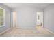 Spacious bedroom with neutral carpet, ample natural light, and ensuite bath access, for a restful sanctuary at 1728 Devon Sw Dr, Atlanta, GA 30311